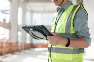 FM engineer using CAFM mobile app on site
