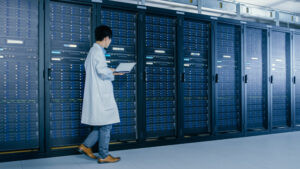 Data centre IT specialist making rounds and ensuring everything is functioning properly