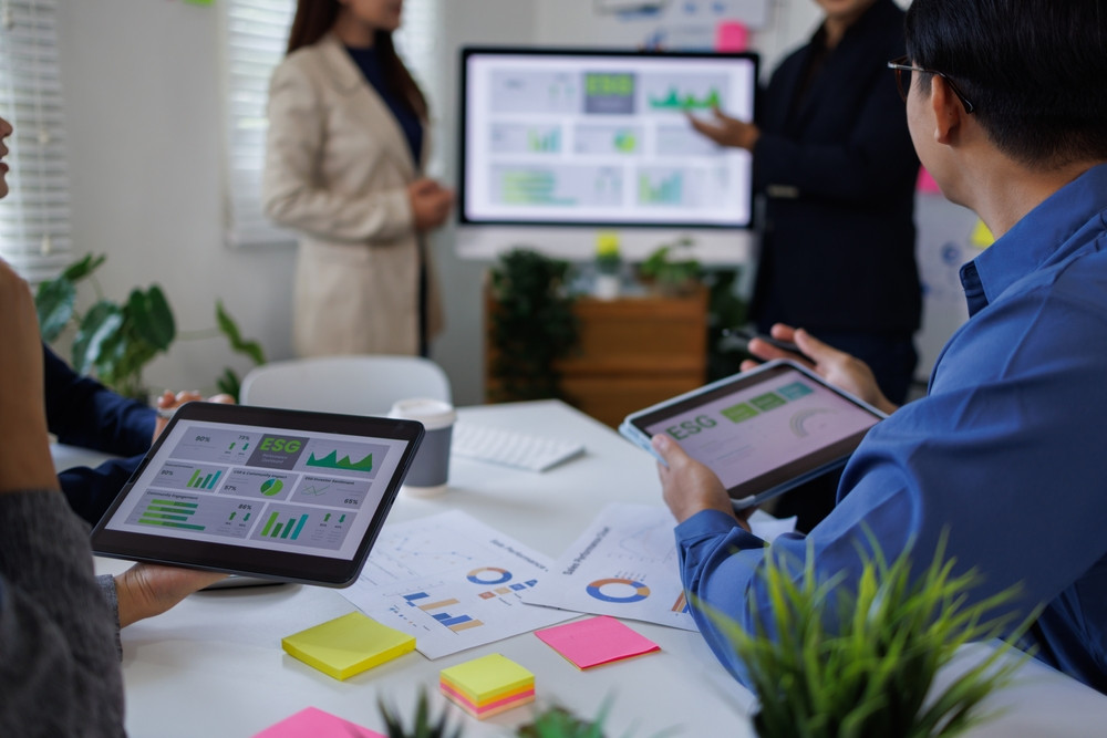 Executive team discussing ESG carbon arbitrage strategy and facilities management compliance investment