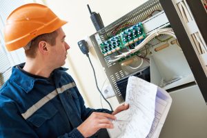 Engineer maintaining hard FM systems as part of an integrated facility management model
