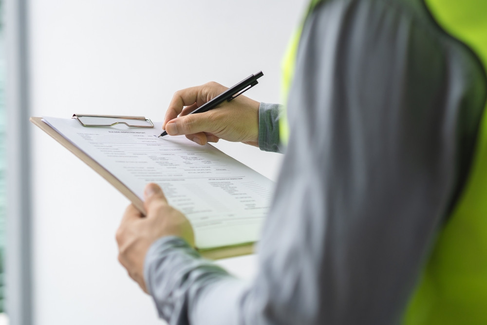 Compliance auditor conducting an inspection as part of how to audit building compliance