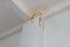 Water damage in a commercial building stairwell from a leaking roof