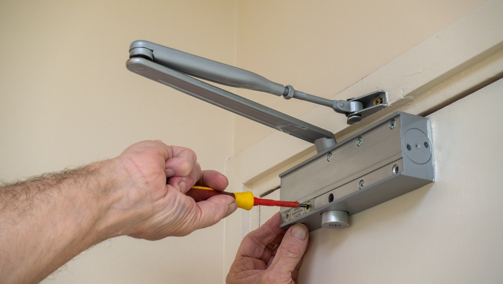 Inspecting a fire door, an example of what is commercial building maintenance in practice