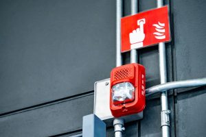 Fire door alarms, closer, frame and seals during a commercial building inspection